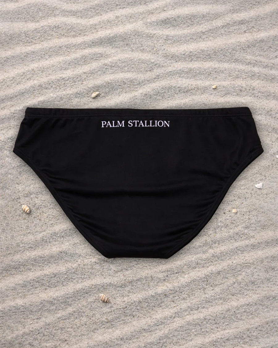Black swim brief front view with white drawstring and lining, low-rise fit, recycled stretch fabric, designed and made in Australia