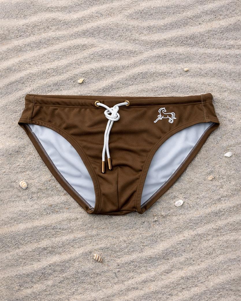Brown swim brief front view with white drawstring and lining, low-rise fit, recycled stretch fabric, designed and made in Australia